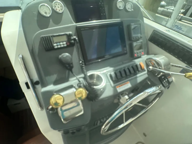 Slide: The Image of 2007 Tiara Yachts 3000 Open cabin interior with beige seating and floral-patterned bedding. - 29