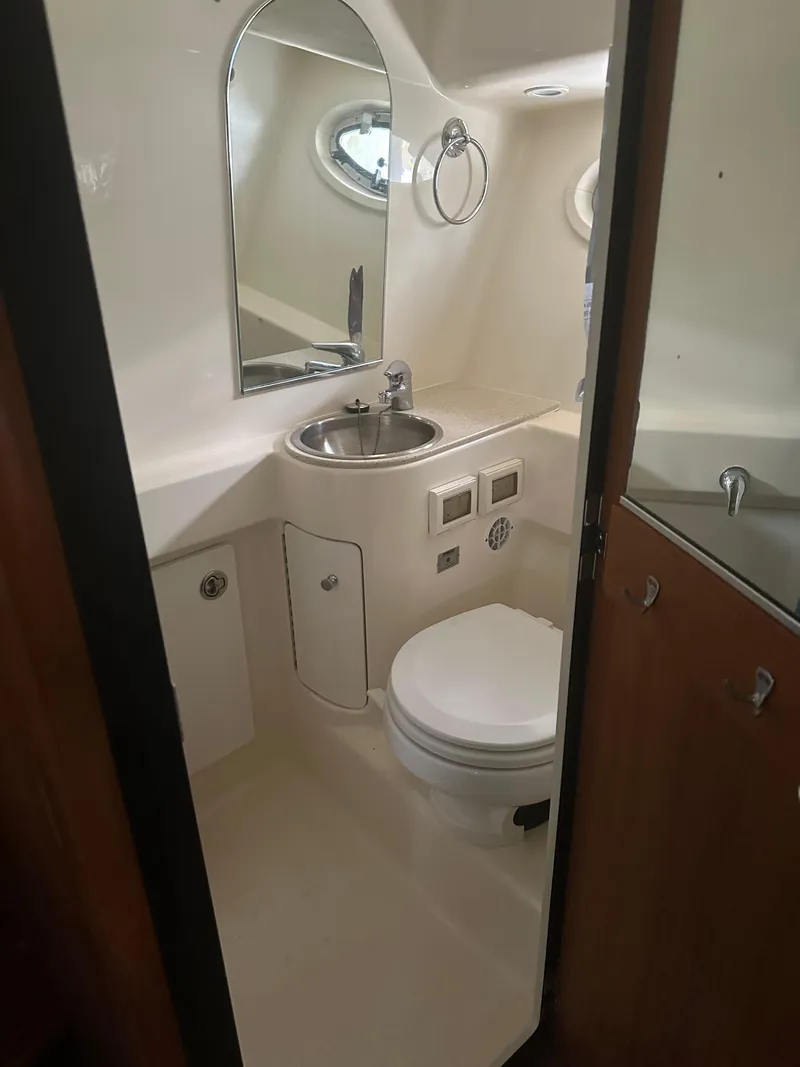 Slide: The Image of Engine compartment of a 2007 Tiara Yachts 3000 Open, showcasing mechanical components and battery. - 37