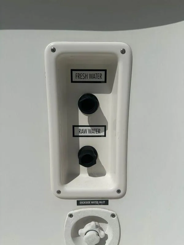 Slide: The Image of Engine components of a 2007 Tiara Yachts 3000 Open, showcasing hoses and metal parts. - 40