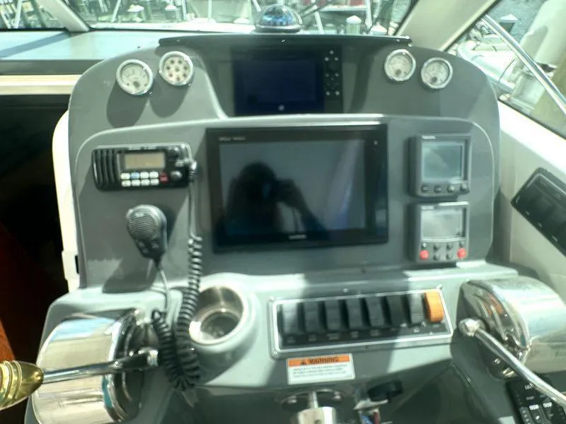 Slide: The Image of 2007 Tiara Yachts 3000 Open boat deck, docked in a marina under a clear sky. - 9