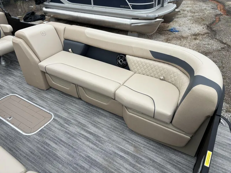 Slide: The Image of Luxurious seating on 2025 Godfrey SWEETWATER 2286 SB pontoon boat, featuring beige upholstery. - 11