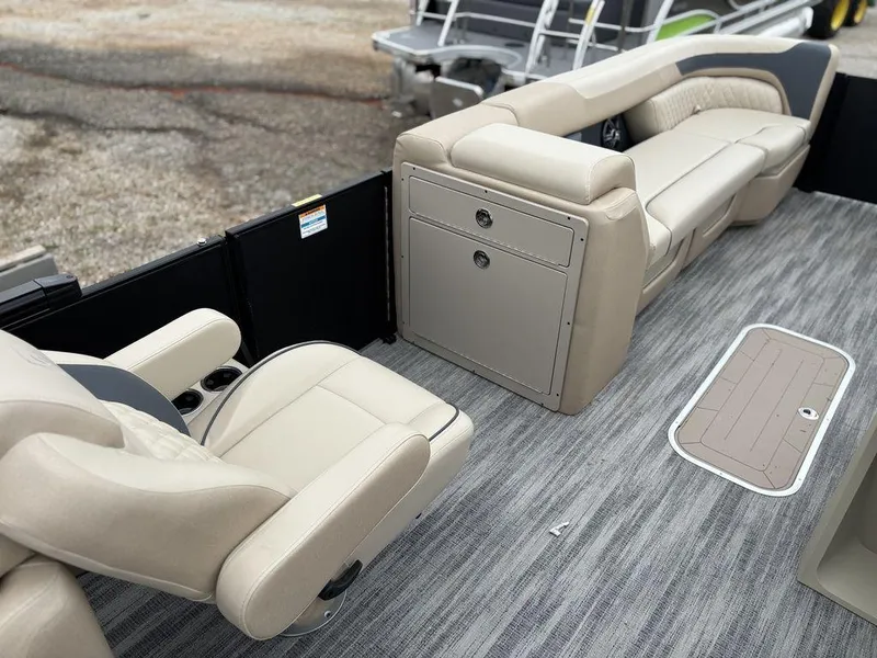 Slide: The Image of 2025 Godfrey SWEETWATER 2286 SB pontoon boat interior with beige seating and storage. - 15