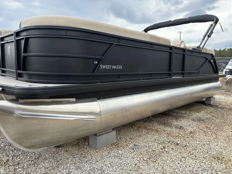 Slide: The Image of 2025 Godfrey SWEETWATER 2286 SB pontoon boat on gravel, featuring sleek black design. - 4