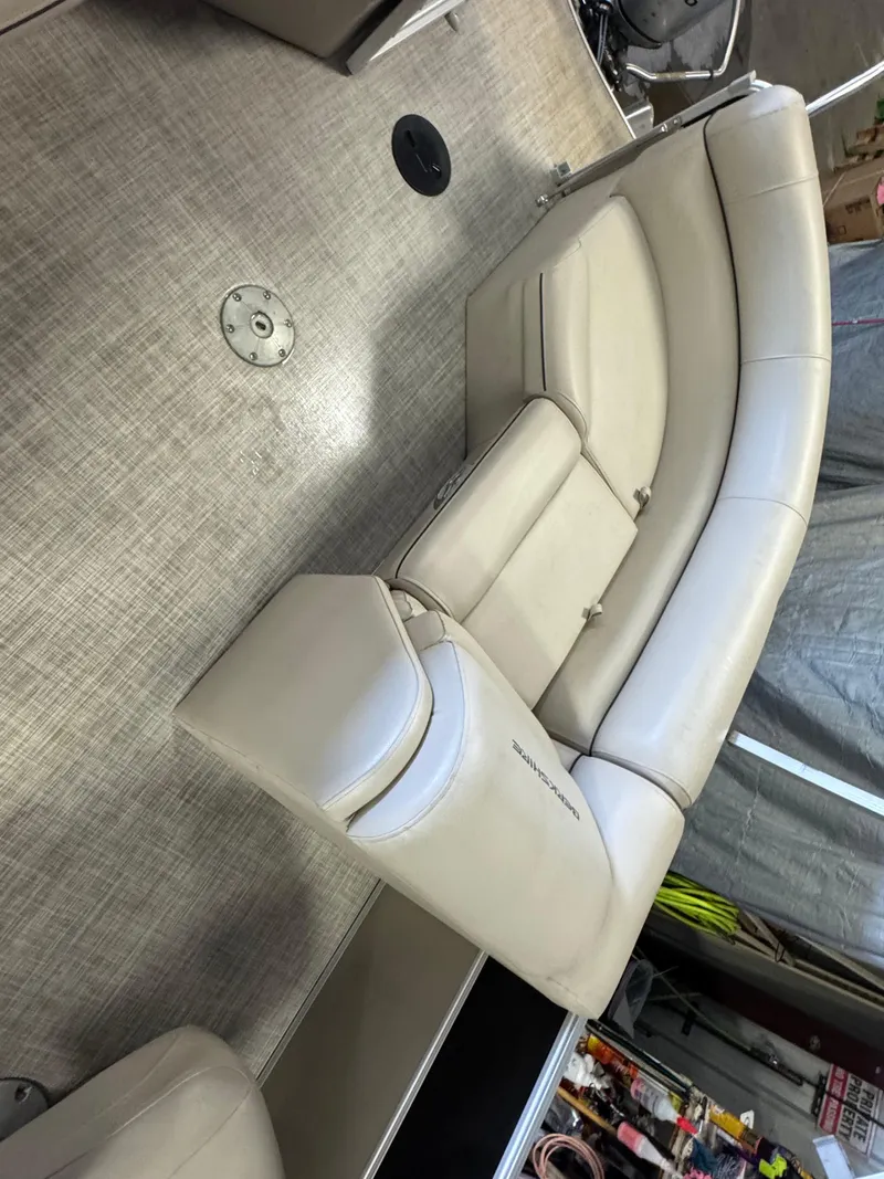 Slide: The Image of 2020 Berkshire 22RFX boat interior with beige seating and textured flooring. - 12