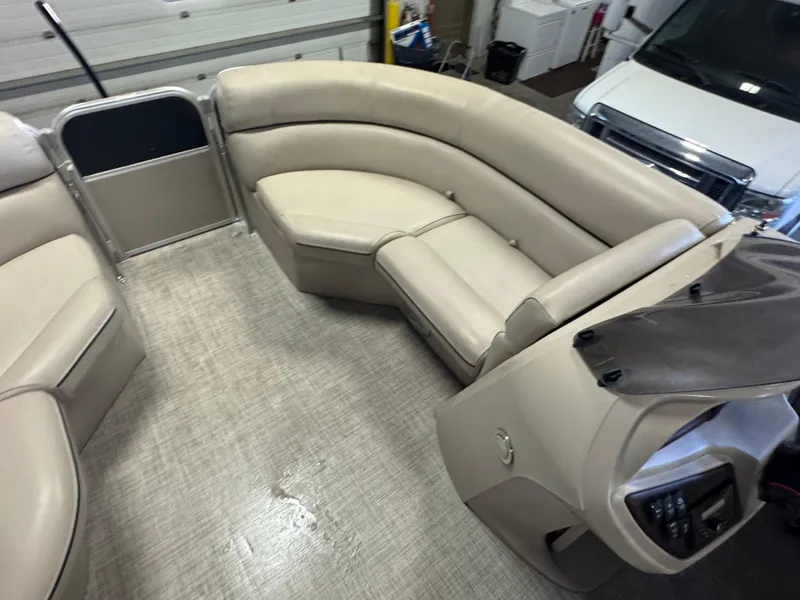 Slide: The Image of 2020 Berkshire 22RFX pontoon boat interior with beige seating and helm. - 14