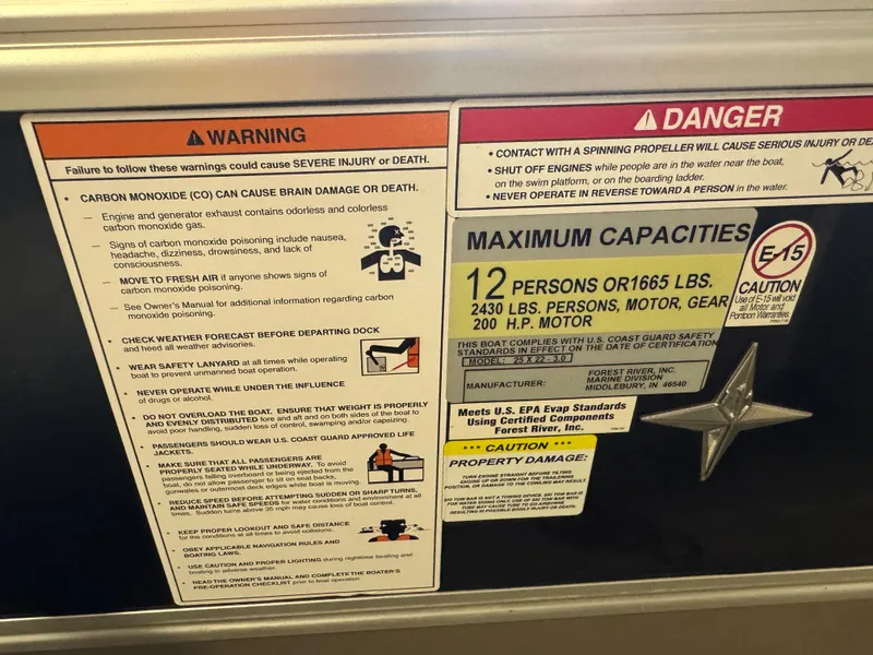 Slide: The Image of ```json
{
  "alt_text": "Warning and capacity labels on 2020 Berkshire 22RFX boat."
}
``` - 18