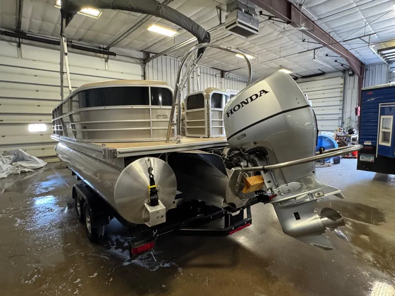 Slide: The Image of 2020 Berkshire 22RFX pontoon boat with Honda outboard motor in a garage. - 3