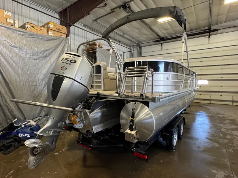 Slide: The Image of 2020 Berkshire 22RFX pontoon boat with Honda 150 engine in a garage setting. - 4