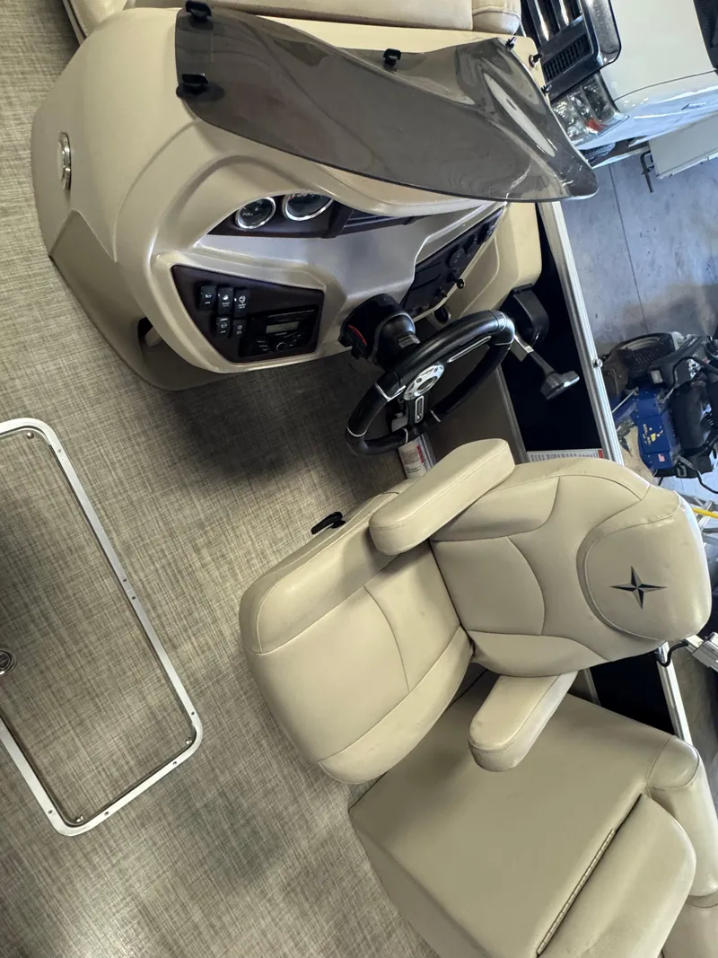 Slide: The Image of 2020 Berkshire 22RFX boat interior with beige captain's chair and control panel. - 8