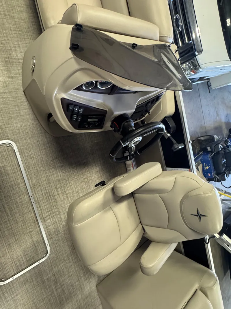 Slide: The Image of Captain's chair and console of 2020 Berkshire 22RFX boat, featuring beige upholstery. - 9
