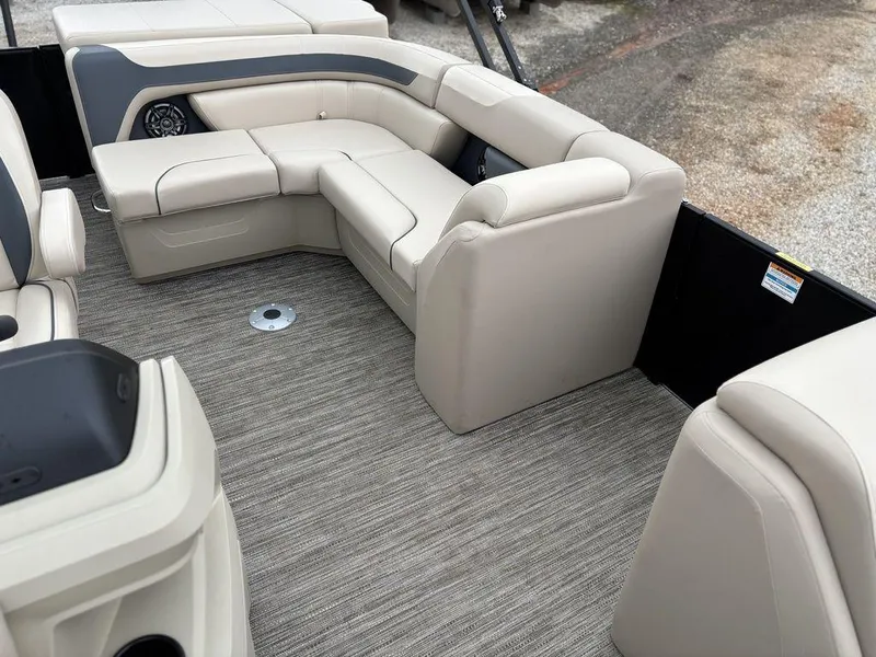 Slide: The Image of 2025 Godfrey Sweetwater 2086 C pontoon boat interior with beige seating and carpet flooring. - 10