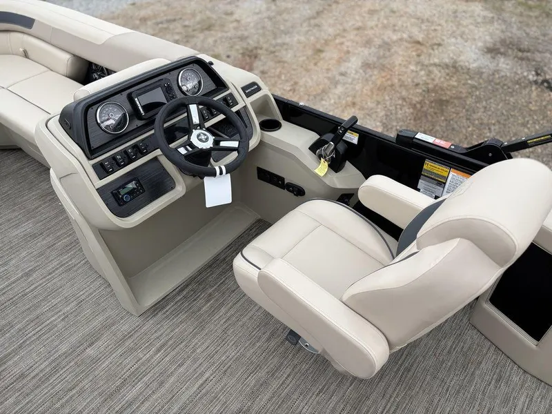 Slide: The Image of 2025 Godfrey Sweetwater 2086 C boat interior with steering console and beige seating. - 12