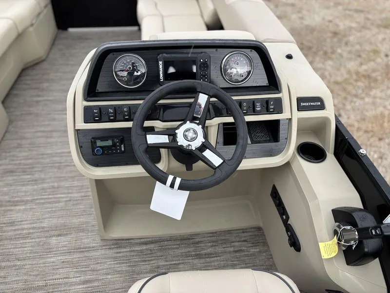 Slide: The Image of 2025 Godfrey Sweetwater 2086 C boat dashboard with steering wheel and controls. - 13