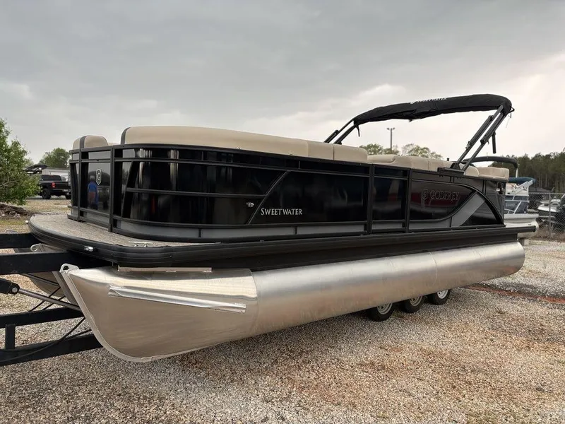 Slide: The Image of 2025 Godfrey Sweetwater 2086 C pontoon boat with canopy, parked on gravel. - 6