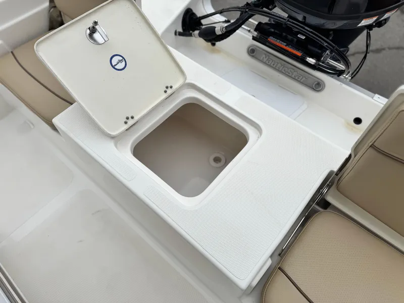 Slide: The Image of 2018 NauticStar 1910 boat storage compartment with open lid, showcasing interior space. - 15