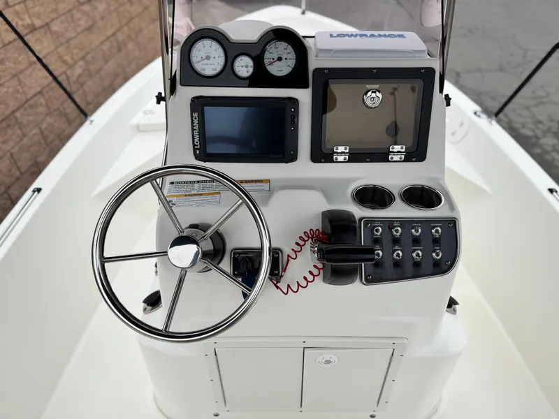 Slide: The Image of 2018 NauticStar 1910 boat console with steering wheel, gauges, and navigation equipment. - 19