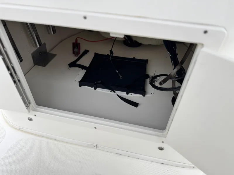 Slide: The Image of Open storage compartment in 2018 NauticStar 1910 boat, showing interior details. - 21