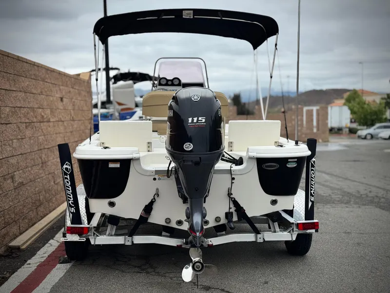 Slide: The Image of 2018 NauticStar 1910 boat with Yamaha 115 engine, parked on a trailer. - 3