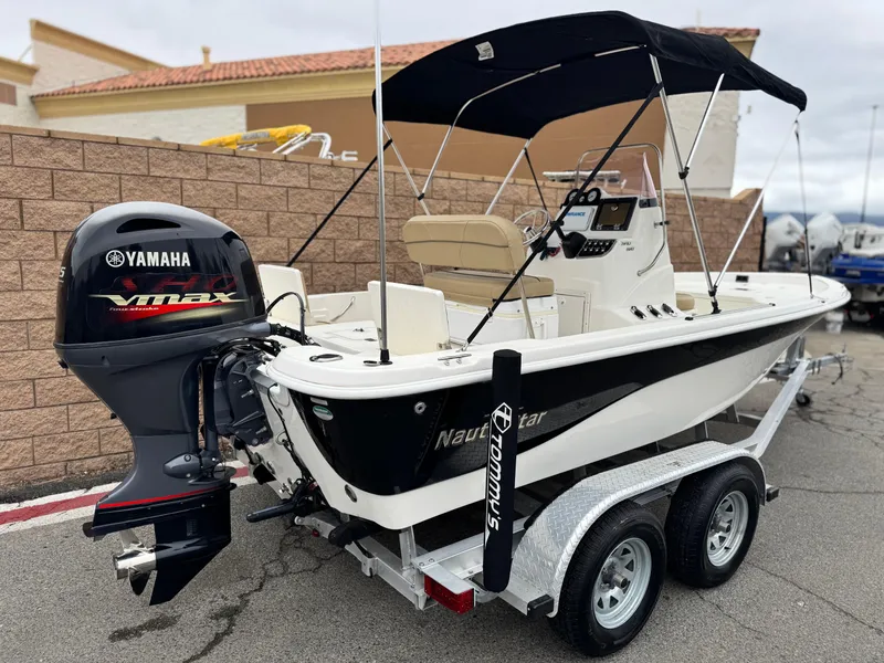 Slide: The Image of 2018 NauticStar 1910 boat with Yamaha VMAX engine on trailer, parked outdoors. - 4