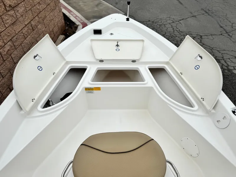 Slide: The Image of 2018 NauticStar 1910 boat interior with open storage compartments and seating. - 8