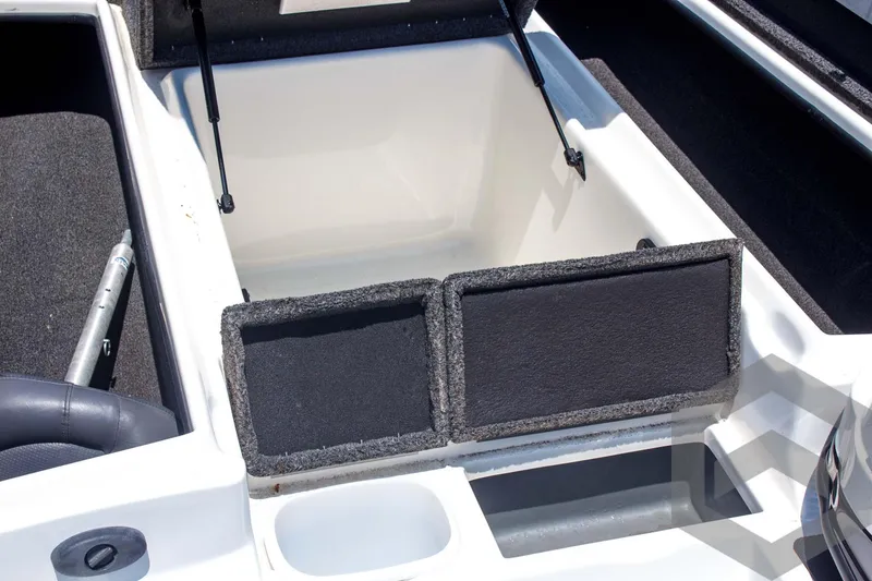 Slide: The Image of 2014 Nitro Z Series Z-7 boat storage compartment with open lid and carpeted interior. - 19