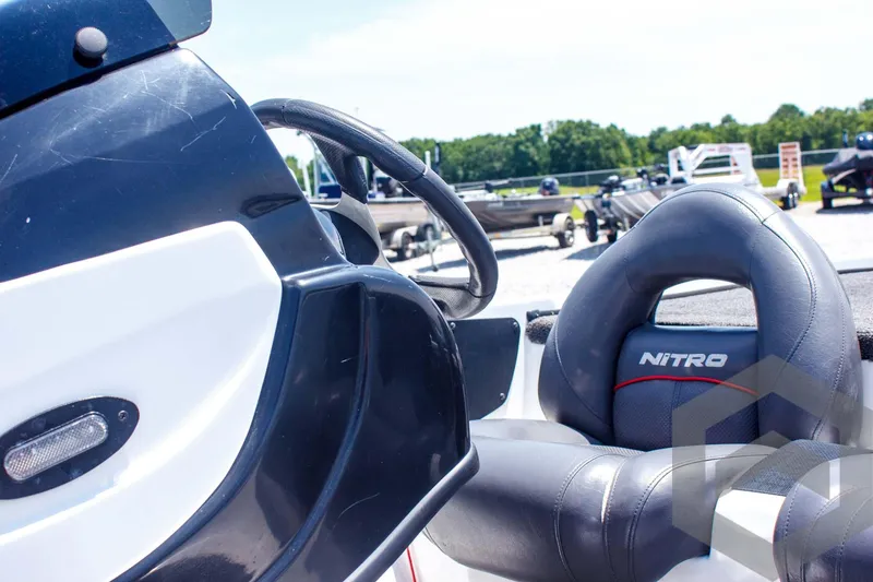 Slide: The Image of 2014 Nitro Z Series Z-7 boat interior with steering wheel and branded seat. - 26