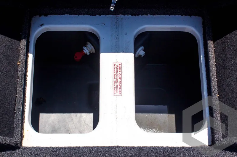 Slide: The Image of 2014 Nitro Z Series Z-7 livewell compartments, open and empty, with visible plumbing fixtures. - 36