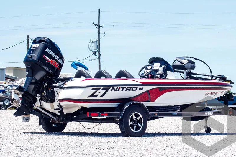 Slide: The Image of 2014 Nitro Z Series Z-7 boat with Mercury engine, parked on gravel, side view. - 5