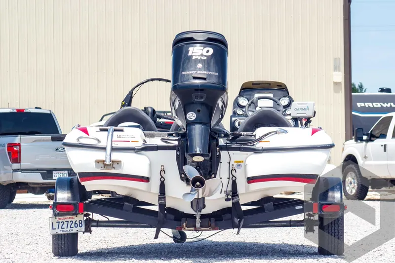 Slide: The Image of 2014 Nitro Z Series Z-7 boat with 150 Pro motor on trailer, parked outdoors. - 6