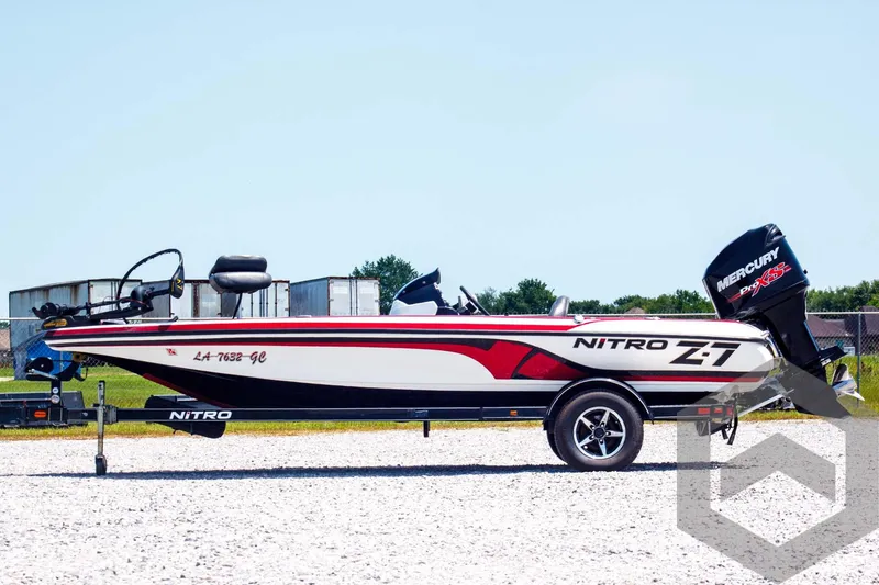 Slide: The Image of 2014 Nitro Z Series Z-7 boat with Mercury engine, parked on gravel. - 8