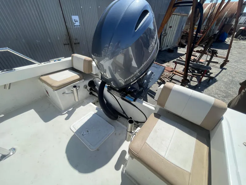 Slide: The Image of 2017 Parker 1801 CC boat interior with seating and outboard motor. - 10