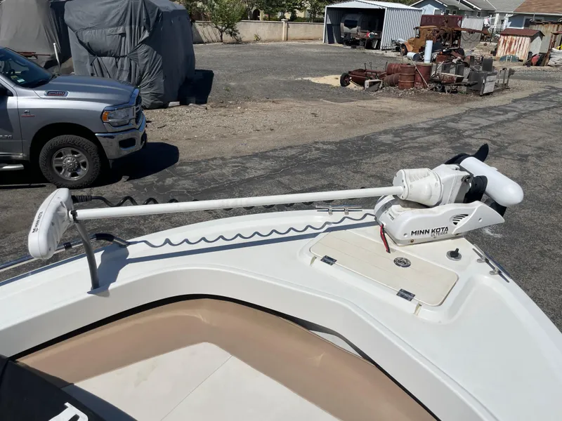 Slide: The Image of 2017 Parker 1801 CC boat with Minn Kota trolling motor in a parking area. - 11