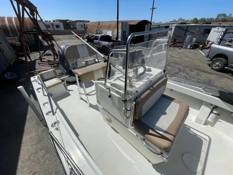 Slide: The Image of 2017 Parker 1801 CC boat with center console and seating, parked in an outdoor lot. - 13