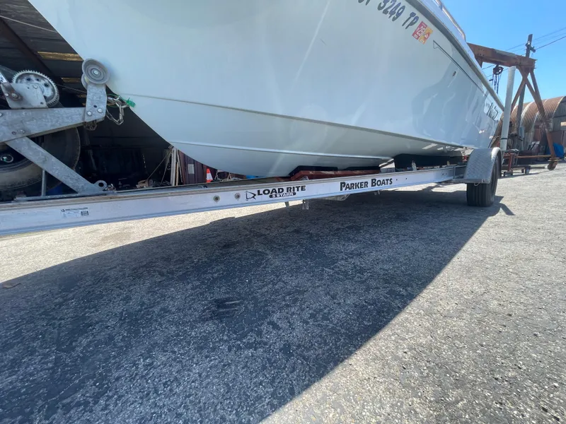 Slide: The Image of 2017 Parker 1801 CC boat on Load Rite trailer in a marina setting. - 15