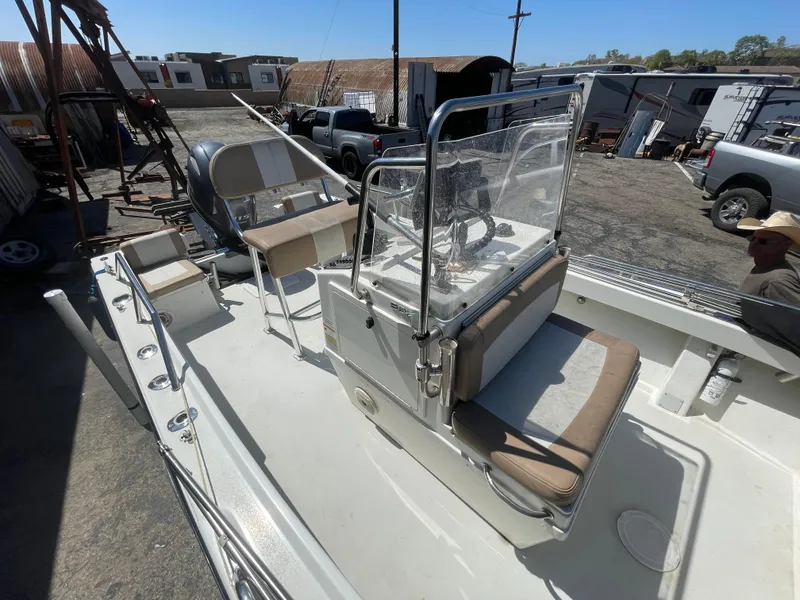 Slide: The Image of 2017 Parker 1801 CC boat with center console and seating, parked in an outdoor lot. - 16
