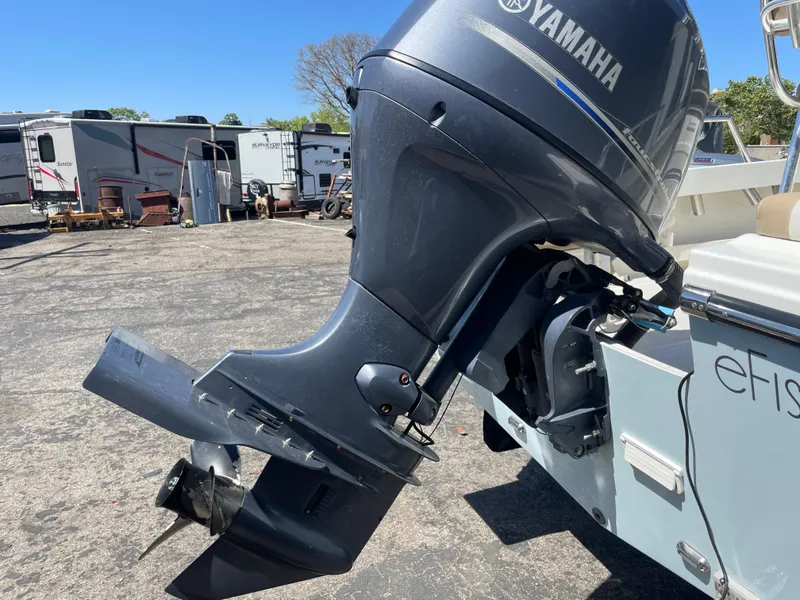 Slide: The Image of Yamaha outboard motor on a 2017 Parker 1801 CC boat, parked outdoors. - 20