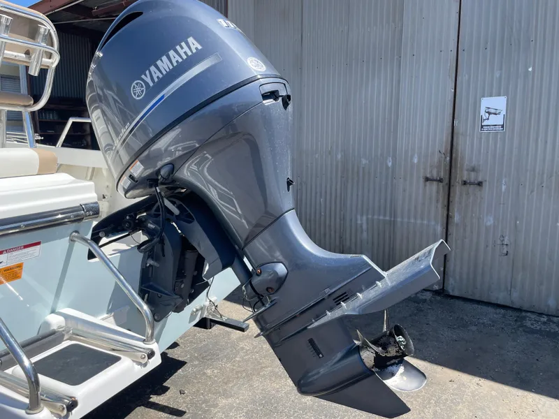 Slide: The Image of 2017 Parker 1801 CC boat with Yamaha outboard motor in a garage setting. - 21