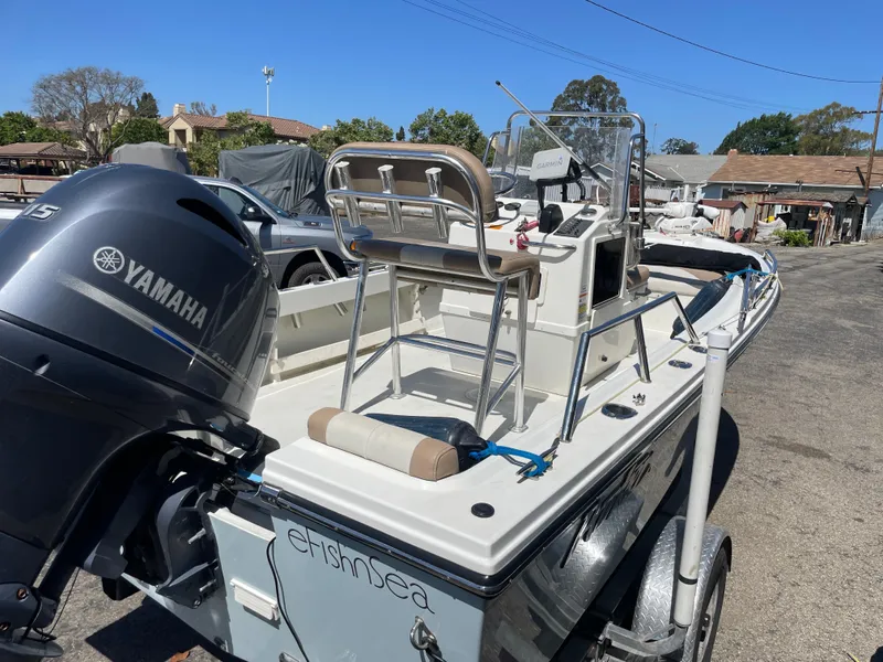 Slide: The Image of 2017 Parker 1801 CC boat with Yamaha engine on a trailer, parked outdoors. - 3