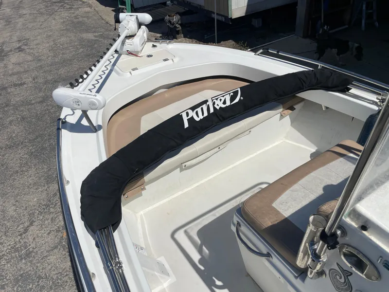 Slide: The Image of 2017 Parker 1801 CC boat with protective cover on deck, featuring seating and equipment. - 6