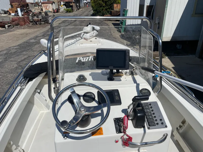 Slide: The Image of 2017 Parker 1801 CC boat dashboard with steering wheel and navigation equipment. - 8