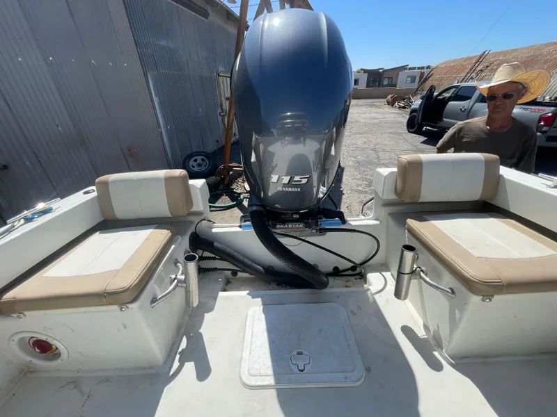 Slide: The Image of 2017 Parker 1801 CC boat with Yamaha 115 engine, beige seating, and outdoor setting. - 9