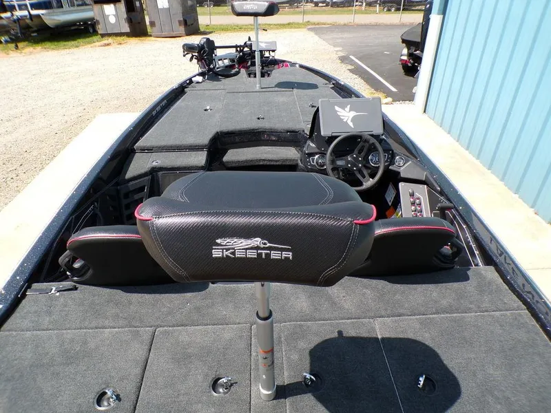 Slide: The Image of 2025 Skeeter ZXR19 boat interior with steering wheel and seating. - 10
