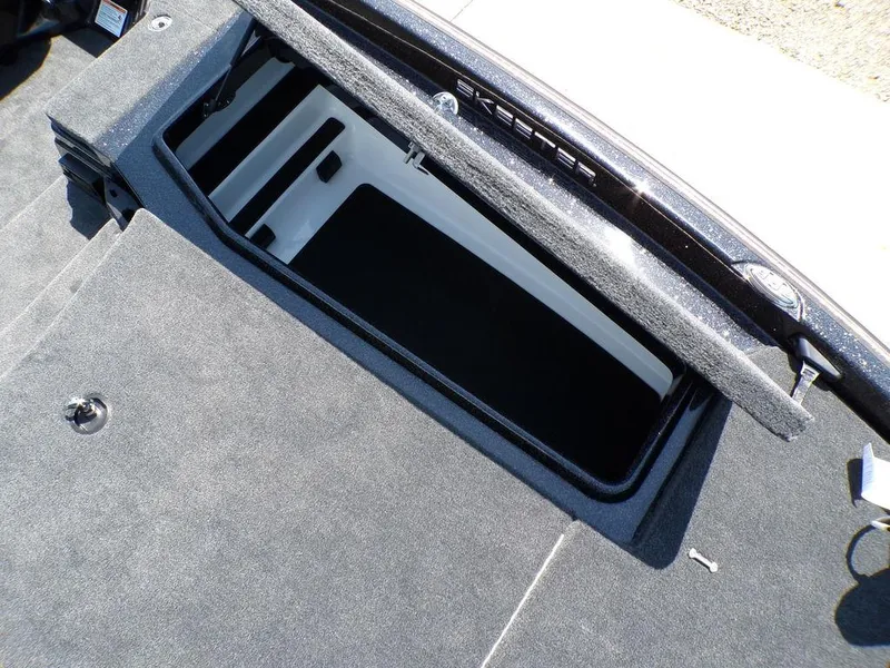 Slide: The Image of 2025 Skeeter ZXR19 boat storage compartment with open lid, showcasing interior space. - 11