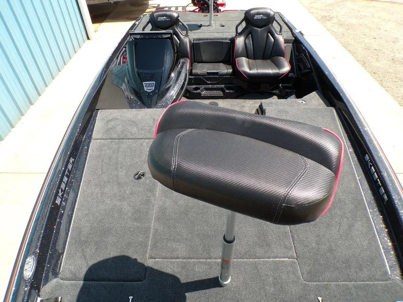 Slide: The Image of 2025 Skeeter ZXR19 boat interior with seating and carpeted deck. - 14