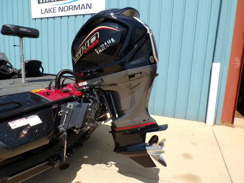 Slide: The Image of 2025 Skeeter ZXR19 boat with Yamaha outboard motor, parked near blue building. - 22