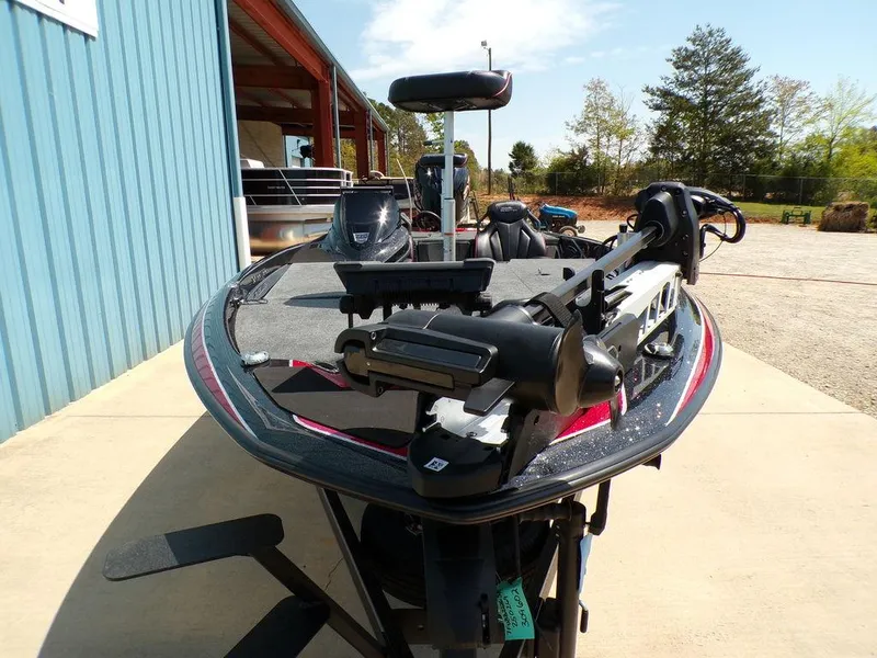 Slide: The Image of 2025 Skeeter ZXR19 fishing boat with advanced equipment, parked outdoors. - 24