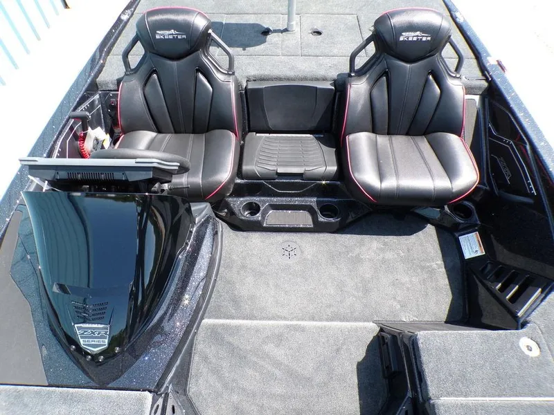 Slide: The Image of 2025 Skeeter ZXR19 boat interior with black leather seats and modern dashboard. - 7