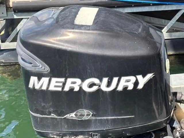 Slide: The Image of Mercury outboard motor on 2007 Avalon Windjammer RC - 22' boat, docked on water. - 13