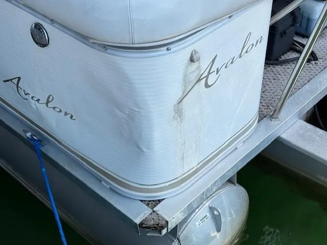 Slide: The Image of 2007 Avalon Windjammer RC boat, 22 feet, docked with visible wear and tear. - 15