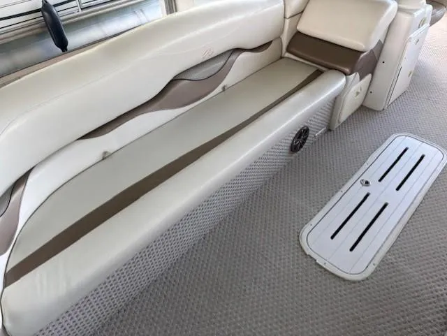 Slide: The Image of 2007 Avalon Windjammer RC 22' boat interior with beige seating and carpeted flooring. - 3
